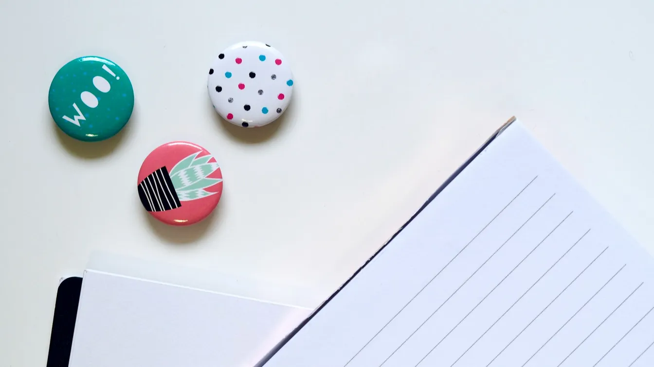 a notebook with polka dot magnets on it